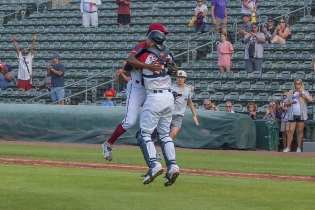 Alex Valdez of the Kansas City Monarchs leaps into the arms of teammate J.C. Escarra