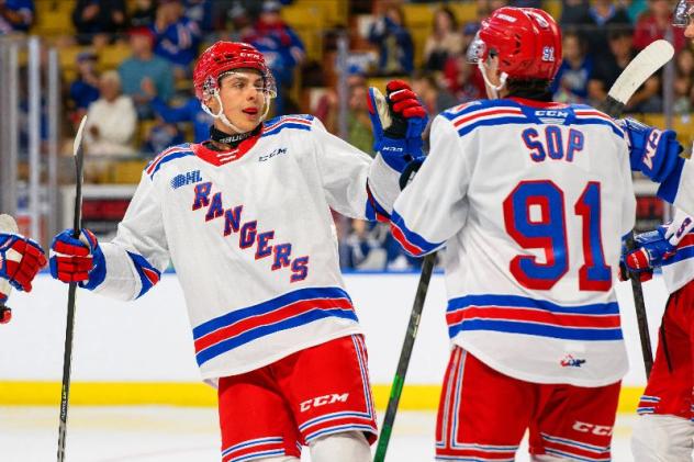 Kitchener Rangers exchange high fives following a goal against the Guelph Storm