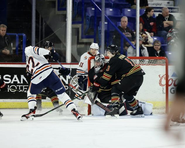 Vancouver Giants' Damian Palmeri and Jesper Vikman battle Kamloops Blazers' Daylan Kuefler