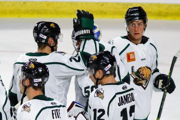 Utah Grizzlies exchange congratulations after a win