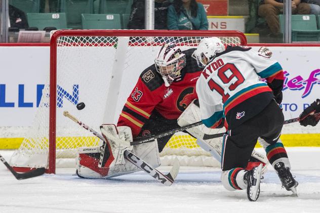 Kelowna Rockets' Adam Kydd battles Prince George Cougars' Nick McBride