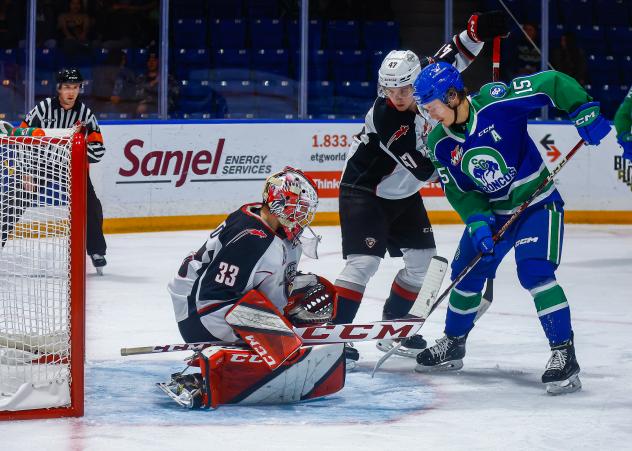 Vancouver Giants' Brett Mirwald battles Swift Current Broncos' Raphael Pelletier